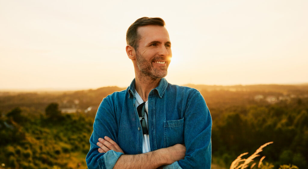 Older gentleman smiling, enjoying the view.