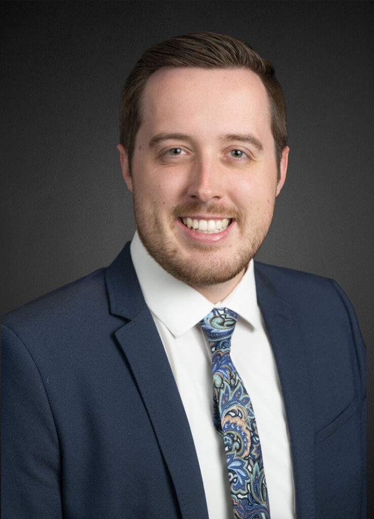 Dr. Connor Young, OD headshot against a black background.