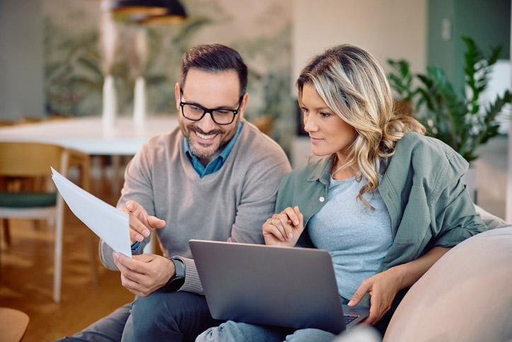 accepted insurance being researched by Two adults sitting on couch while reviewing eye care information