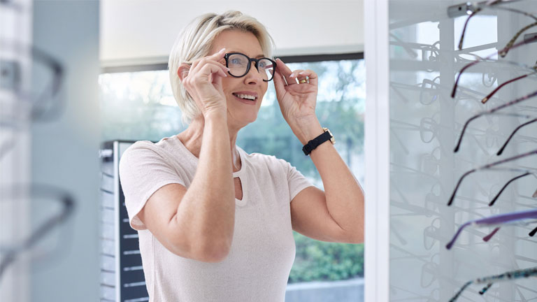 Imagery of a patient choosing prescription glasses.