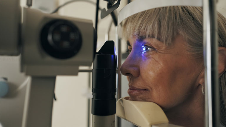 Imagery of an older woman having intraocular pressure testing.