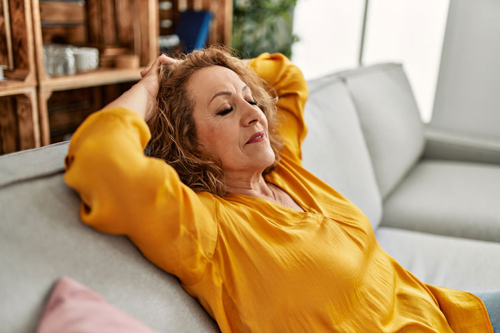 Patient resting on a couch during recovery after SLT glaucoma treatment, representing minimal downtime following selective laser trabeculoplasty. Patient