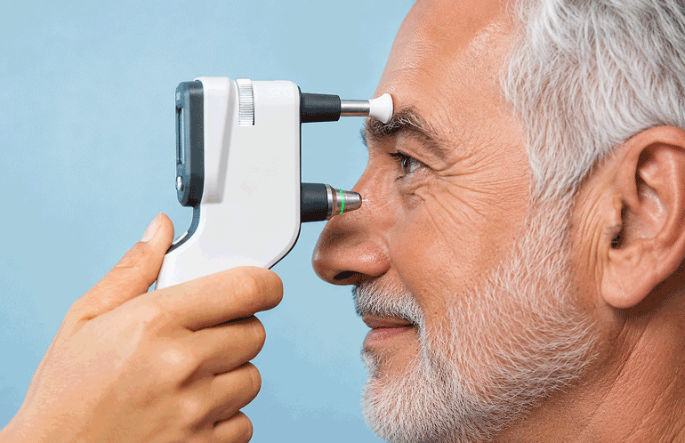 Senior man receiving an eye pressure test with a handheld tonometer, illustrating minimally invasive glaucoma surgery evaluation at M & M Eye Institute.
